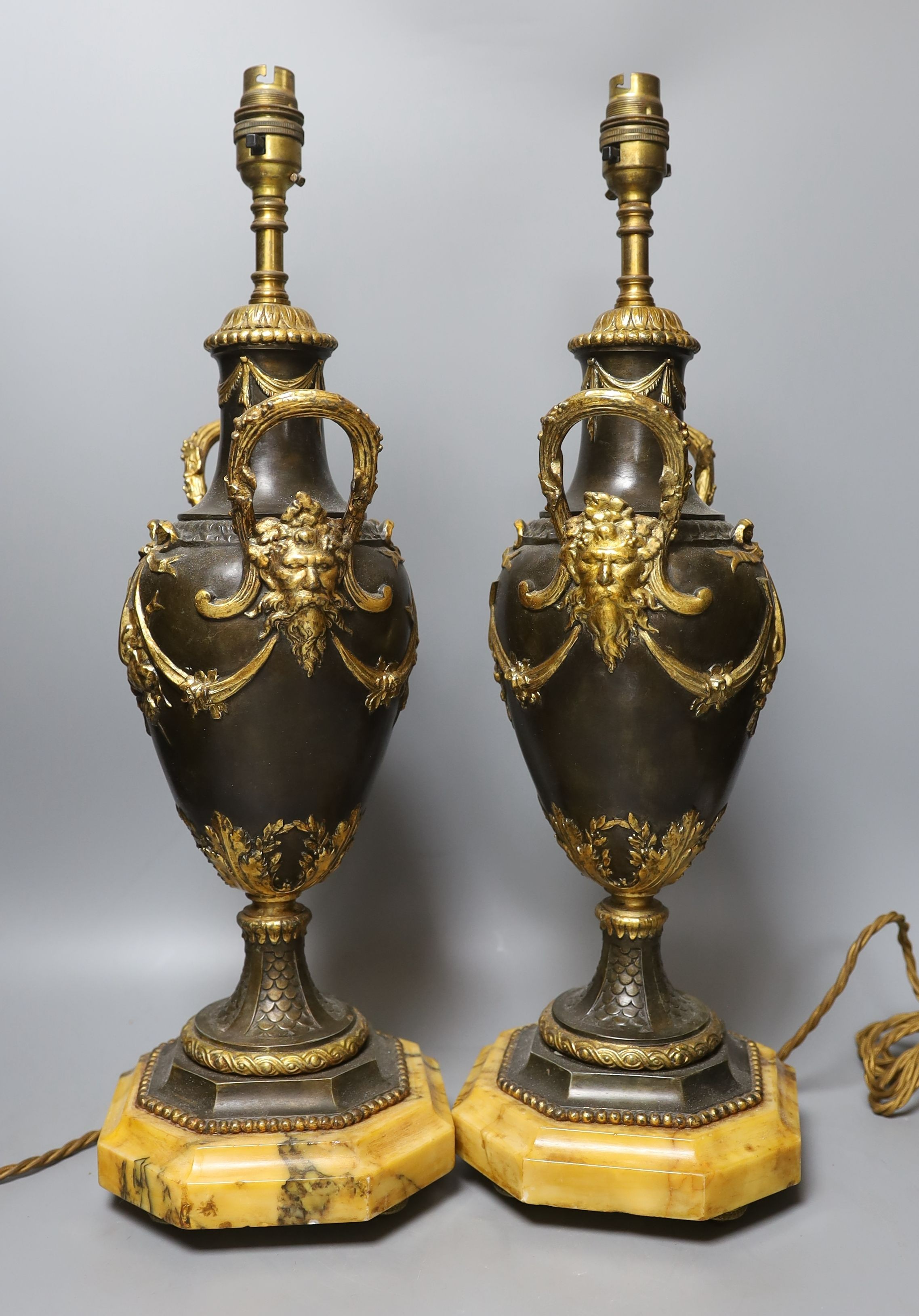 A pair of decorative brass and gilt ‘urn' lamps - 51cm tall